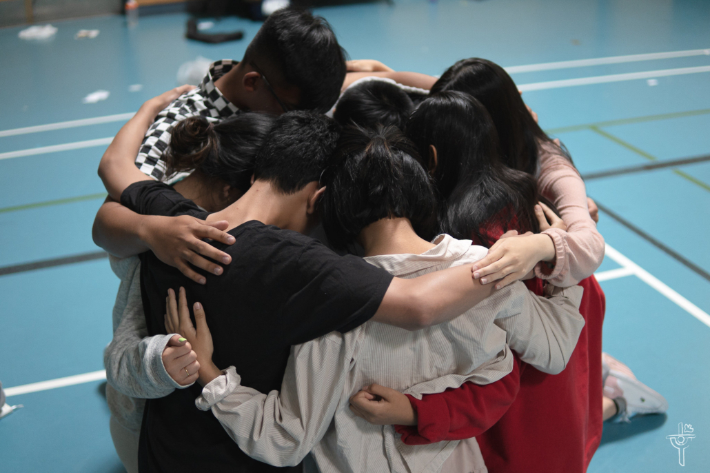 A bullseye group hugging and praying with each other during Pacific East Cluster's Discovery Camp Chosen 2019